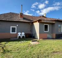A family house in Mýtne Ludany with a spacious garden under a clear blue sky.