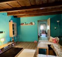 A room in a family house with a wooden decor floor and comfortable sofas.