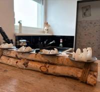 Wooden decor with white candles on a wooden table in the kitchen of a 3-room apartment.