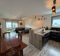 Living room with a kitchen in a 3-room apartment, floor with a wooden decor.