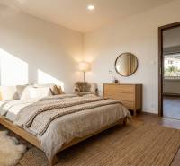 A bedroom in a 3-room apartment with a wooden decor floor, cozy accessories, and lighting.