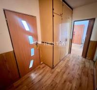 A hallway with built-in wardrobes and doors in a 3-room apartment.