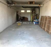 A garage in a 3-room apartment with stored items and a bicycle.