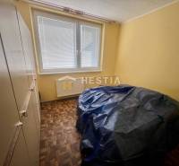 A room in a 3-room apartment with yellow walls, parquet flooring, large window.