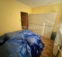 A room with a wardrobe, radiator, and covered furniture in a 3-room apartment.