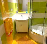 A colorful bathroom in a 3-room apartment with a modern shower cabin and bright tiles.