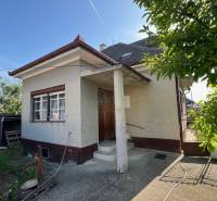A family house in Drahovce on Drahovce Street with a garden and a narrow entrance gate.