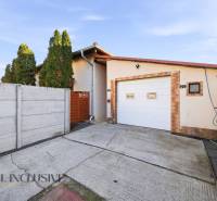 A family house in Hviezdoslavov with a garage, enclosed by a fence, concrete driveway.