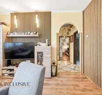 Living room in a family house with a television and a floor with a wooden decor.