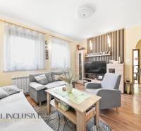Living room in a family house with a sofa, table, television, and floor with a wooden decor.