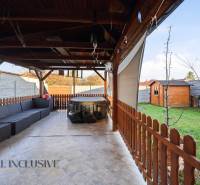 Covered terrace with a sofa and hot tub, garden shelter in a family house in Hviezdoslavov.