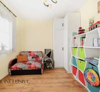 Children's room in a family house with colorful furniture and a wooden decor floor.