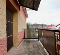 A balcony of a family house on Kalinčiakova Street in Michalovce with a view of the rooftops of houses.