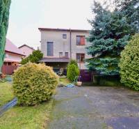 The garden of a family house on Kalinčiakova Street in Michalovce with landscaped greenery and a terrace.