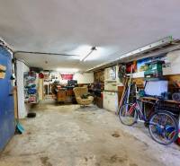 Garage in a family house with tools, a bicycle, and a workbench.