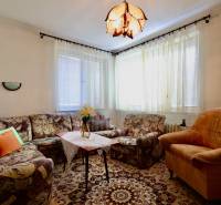 Living room in a family house with comfortable upholstered furniture and a decorative carpet.