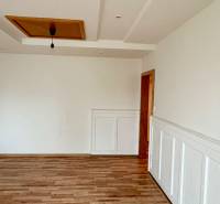 Interior of a 2-room apartment with a wooden decor floor and ceiling finishes.