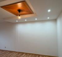 Ceiling lamp and floor with wood decor in a 2-room apartment.