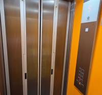 Elevator in the building, with buttons and a display showing the fifth floor.