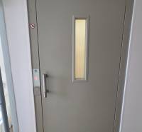 Light gray elevator doors in an apartment building on Humenská Street in Košice, West district.