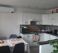 A kitchen in a 3-room apartment with a corner kitchen unit and air conditioning.