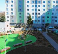 Apartment building on Leningradská Street in Michalovce with a children's playground and parking lot.