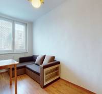Dining room in a 3-room apartment with a wooden decor floor, seating, and a table.
