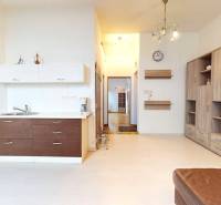 Office interior with a kitchenette and cabinets, floor with wood decor.