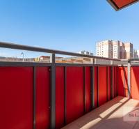 The balcony of a 3-room apartment on Saratovská Street in Bratislava - Dúbravka with a view of the city.