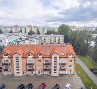 An apartment building with an orange roof in Poprad offers views of the surroundings, including 2-room apartments.
