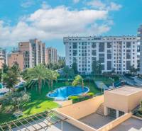 View of residential buildings and a pool in Alicante, 2-bedroom apartment.
