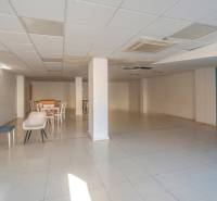 A spacious room with an armchair, a table, and chairs in a 2-room apartment.