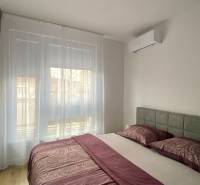 Bedroom in a 2-room apartment with air conditioning and a wooden decor floor.