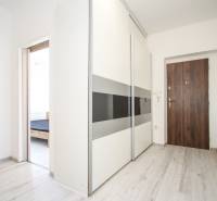 Interior of a 2-room apartment with a built-in wardrobe and flooring with a wood decor.