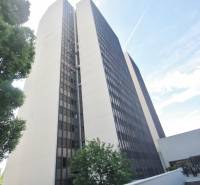 High-rise office building on Kutlíkova Street in Bratislava - Lúky, partially surrounded by greenery.
