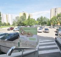 Parking lot on Kutlíkova Street in Bratislava - Meadows surrounded by greenery and apartment buildings.