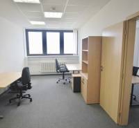 Offices with office furniture, gray carpet, and a light wall, ready for work.