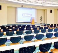 Conference room in offices with a projector and chairs, suitable for presentations.