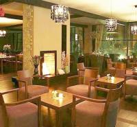 Stylish offices with wood-patterned flooring, comfortable seating, and ambient lighting.