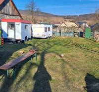 A building plot in Kráľovce Krnišov with a concrete mixer and trailers in the yard.