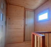 The interior of a cabin with wooden paneling and a floor with a wood decor.