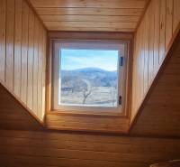 Windows with a view of the hills, wood-paneled, Cabin.