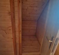 Wooden interior in a cabin with wooden decor and a staircase.