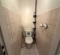 A toilet with tiles and cladding in a 3-room apartment.