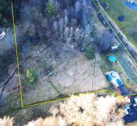 Recreational plots in Župkov with trees and vehicles on the green area.
