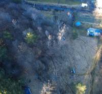 Aerial view of recreational plots in Župkov surrounded by dense trees.