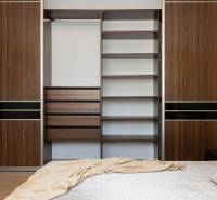 A bedroom in a 2-room apartment with a large built-in wardrobe and a bed.