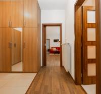 Interior of a 2-room apartment with a built-in wardrobe and flooring with a wood decor.