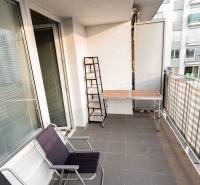Balcony with a terrace, table, and chairs at a 2-room apartment on Hrachova Street in Bratislava.