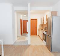 A kitchen with a dining table in a 2-room apartment, floor with wood decor.